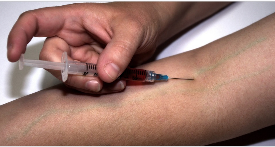 a drug addict admisntering drug by injection